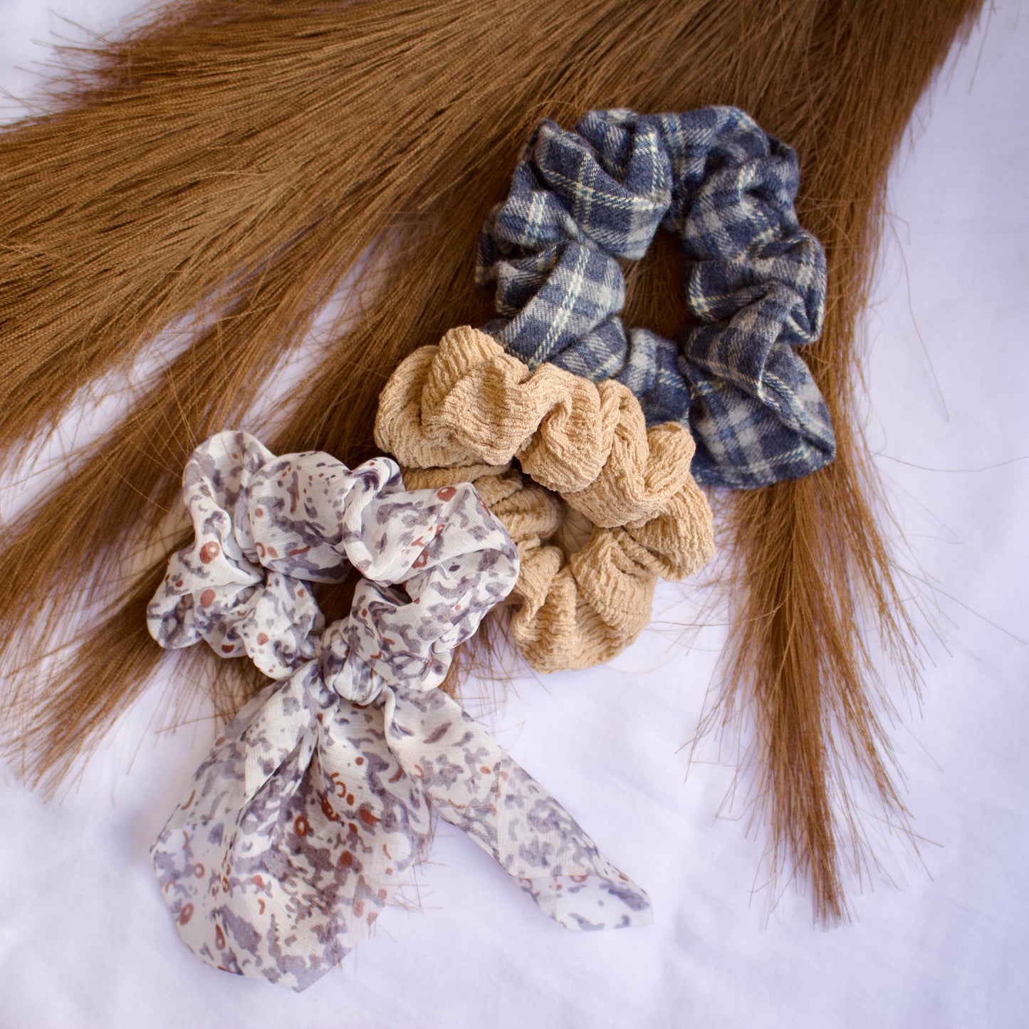 close up of chiffon white, gray and tan scrunchies
