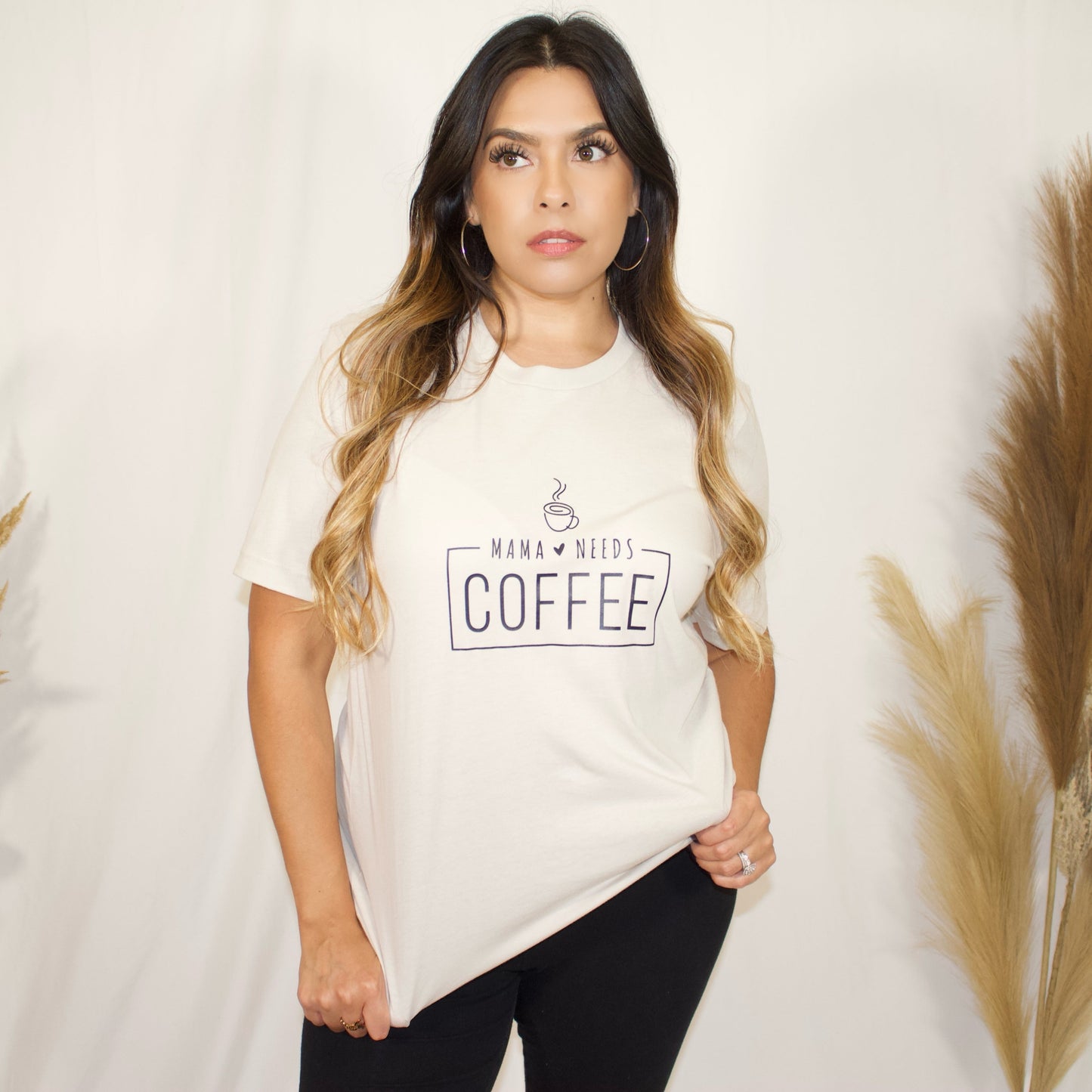 front side of t-shirt in nude color with wording mama needs coffee