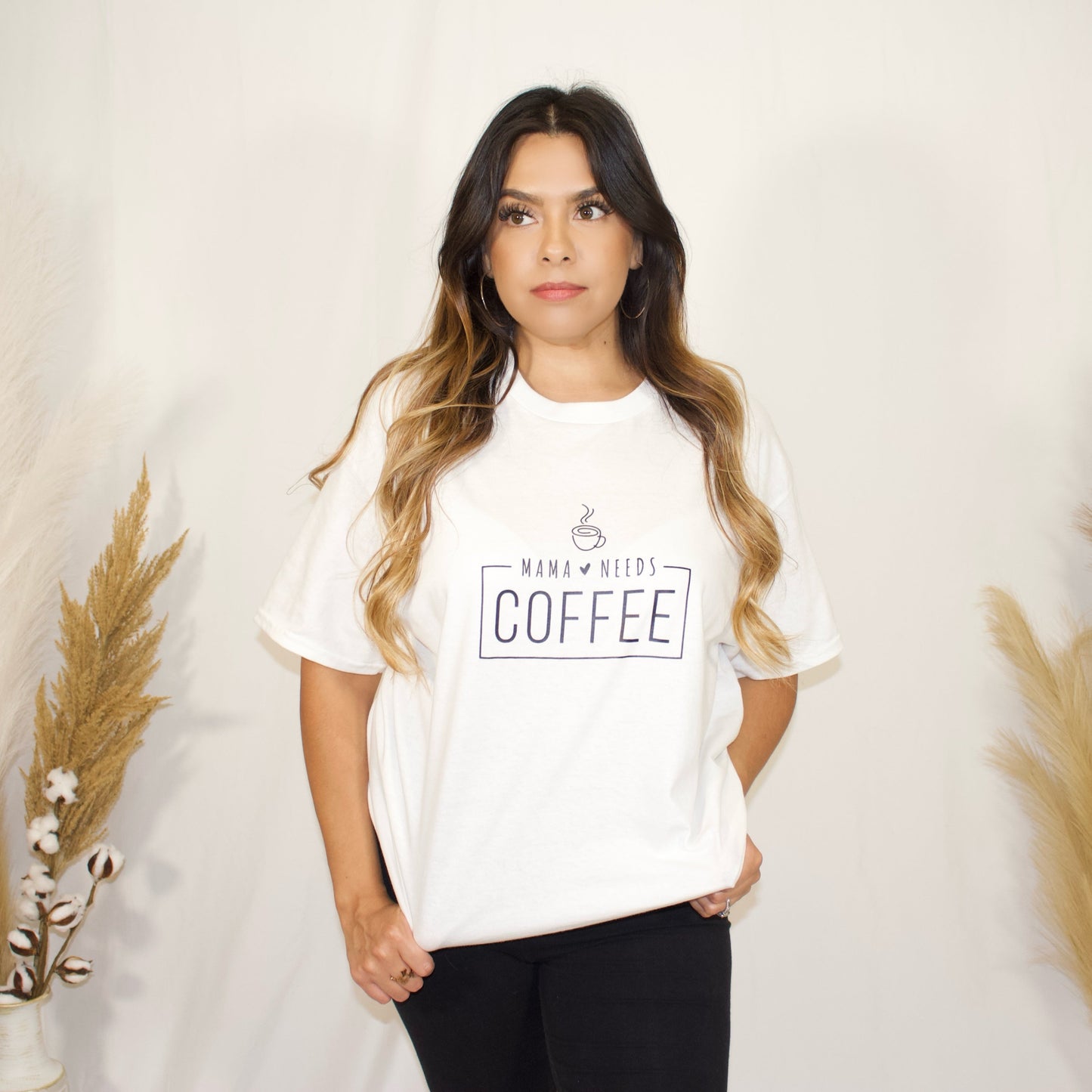 front side of t-shirt in white color with wording mama needs coffee