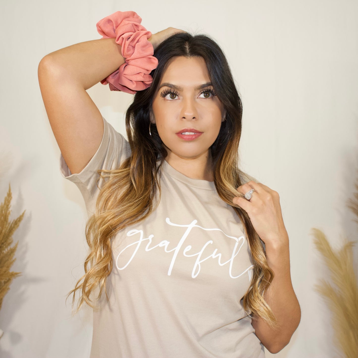 close up, of terracotta jumbo scrunchie on wrist